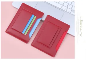 Close-up detail showing card slots of red slim leather passport cover holder on desk