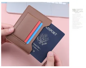 Detailed view of slim brown faux leather passport holder with card slots on pink surface