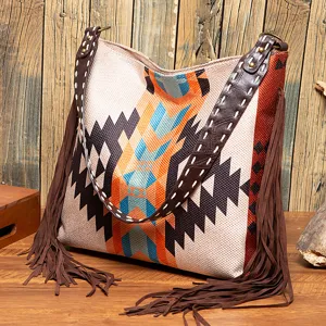 Detail of retro woven cotton linen tote bag with long boho tassels and geometric patterns.