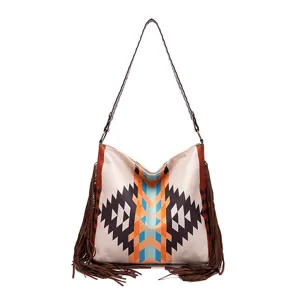 Close-up of retro hobo shoulder bag featuring colorful geometric patterns and long side fringes