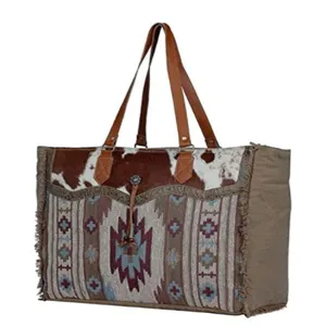 Front view of large bohemian tote bag showing cowhide texture and tribal weaving