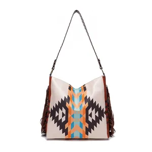 Detailed view of a retro woven cotton linen tote bag with fringe tassels and patterns.