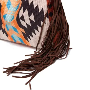 Close-up detail of retro woven pattern and long brown suede fringes on shoulder bag