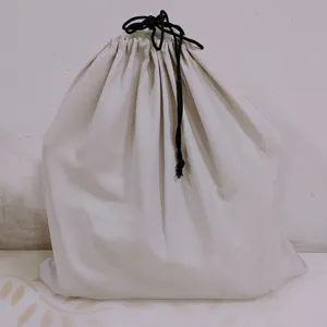 Durable plain beige polyester drawstring dust bag with dual black cords for packaging storage
