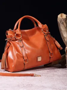 Bolso de mano vintage grande de piel suave naranja con borlas decorativas para mujer