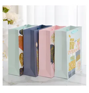 Detailed view of four colorful gift bags featuring elegant gold foil patterns