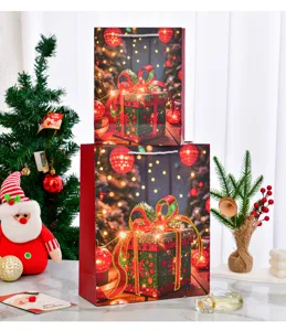 Detailed view of large festive red Christmas gift bags with sparkling bow print