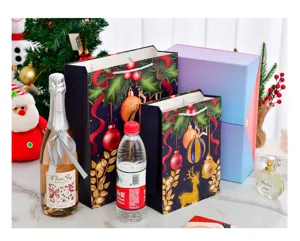 Large navy Christmas gift bags shown with wine and water bottles for size comparison.