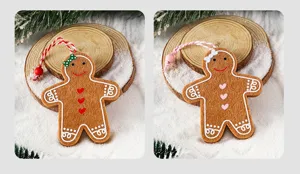 Detail showing two felt gingerbread man Christmas tree ornaments in snow scene