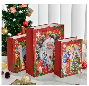 Set of three decorative Santa Claus Christmas gift bags in various sizes for holiday presents.
