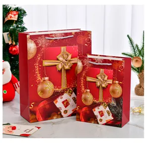 Detailed view of red Christmas gift bags with festive ribbon and ornament patterns