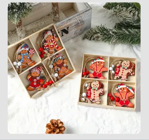 Close-up view of painted wooden gingerbread man Christmas ornaments in rustic gift boxes