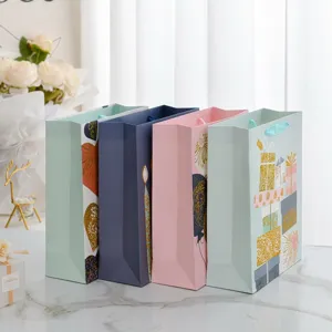 Large assorted festive gift paper bags with gold foil patterns for birthday parties