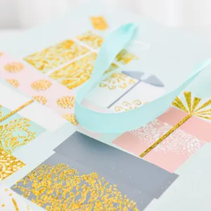 Extra large blue birthday gift bag featuring gold glitter patterns and soft ribbon handles.