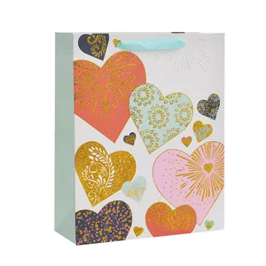 Large gift bag with glitter gold heart patterns for birthday parties