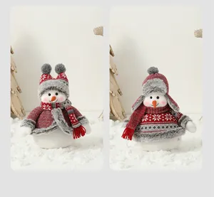 Détail de poupées bonhommes de neige de Noël en peluche avec bonnets et écharpes.