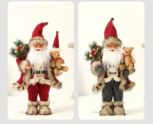 Pair of traditional Santa Claus figurines holding teddy bears for Christmas decor