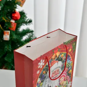 Large festive Christmas gift bag with Santa Claus cartoon and red rope handle
