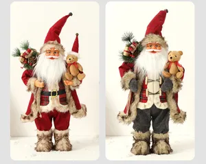 Detailed view of two Santa Claus figurines holding teddy bears in festive red and grey outfits