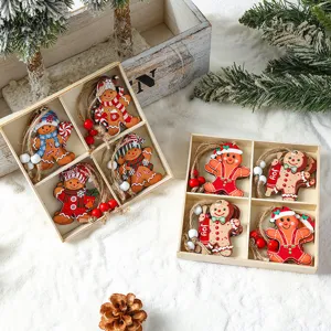 Set of wooden Christmas gingerbread man ornaments for tree decoration presented in gift boxes