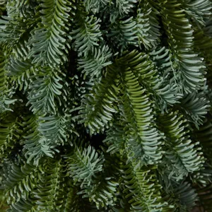 Detailed macro texture of blue-green PE artificial Noble Fir Christmas tree needles