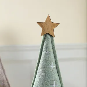 Minimalist light green felt Christmas tree ornament with a wooden star topper for desk.