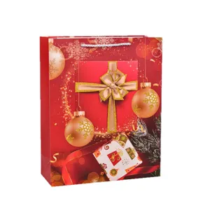 Large red Christmas paper gift bag with festive ornaments and white cord rope handle