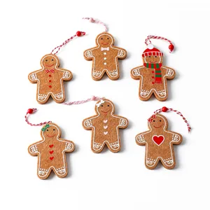 Six assorted felt gingerbread man Christmas ornaments with red and white hanging strings