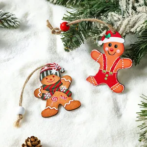 Two charming wooden gingerbread man ornaments on snow for festive Christmas tree decor