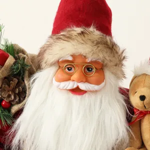 Detailed Santa Claus doll with white beard, red hat, and a small plush teddy bear.
