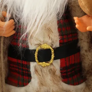 Close-up of Santa Claus doll with red plaid shirt and golden buckle detail
