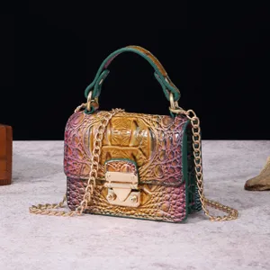 Primer plano del cuero con relieve de cocodrilo y el cierre dorado de este bolso retro