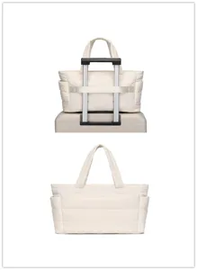 Cream quilted travel tote bag featuring a practical trolley sleeve on a suitcase