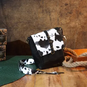 High-definition detail view of a retro western cow print crossbody bag for women