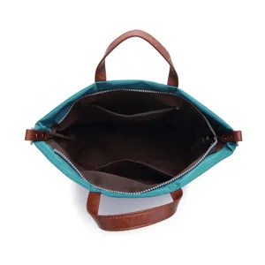 Interior view of teal waterproof nylon tote bag with brown lining and multiple pockets