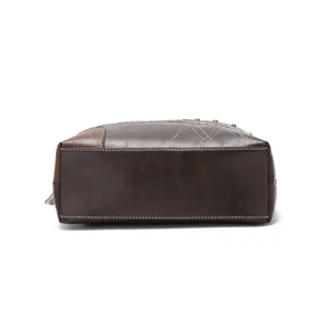 Close-up detail showing the bottom panel and stitching of this vintage brown crossbody bag.
