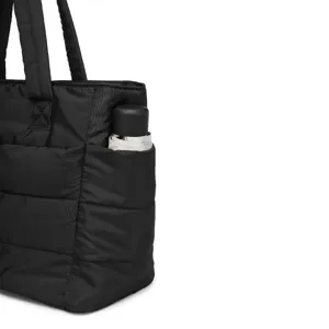 Close-up view of the side pocket on a black quilted travel bag showing an umbrella inside