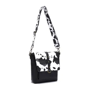 Western style women's crossbody bag with cow print flap and wide shoulder strap