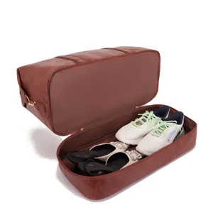 Bolsa de viaje grande de cuero marrón con un compartimento separado para zapatos abajo