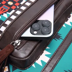 Detailed view of Aztec Bohemian backpack zipper pocket with a smartphone inside