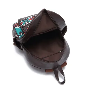 Close-up interior view of a brown faux leather backpack with colorful Aztec pattern