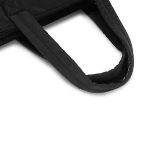 Macro view of the padded handle and stitching detail on a black quilted travel bag
