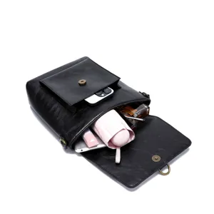 Interior view of vintage black leather crossbody bag showing large storage capacity