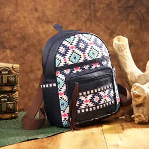 Close-up view of ethnic Aztec bohemian patterned backpack with dark blue base and tassel