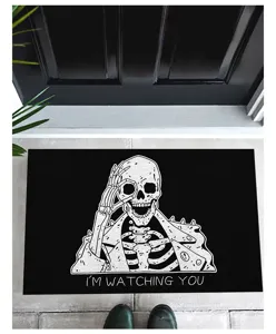 Halloween skeleton floor mat with 'I'M WATCHING YOU' text placed at a house doorway.