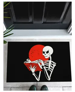 Halloween horror themed doormat with a skeleton reading a book against a red sun