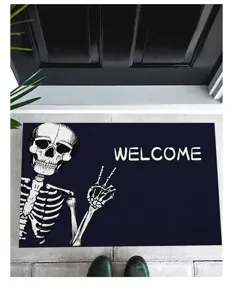 Halloween skeleton doormat with 'WELCOME' text displayed in front of a dark entry door