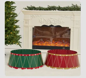 Detailed view of red and green metal Christmas tree collars by a cozy fireplace setting.