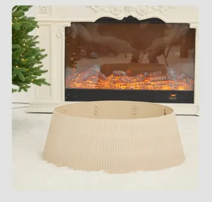 Detailed view of beige ribbed Christmas tree collar placed on white fur rug by fireplace