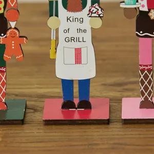 Close-up of wooden nutcracker soldier ornaments on a wooden tabletop for Christmas decor